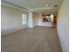 Open living room with tile floor and kitchen access at 8191 Varenna Dr, Sarasota, FL 34231