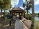 Relaxing gazebo by the lake with brick pathway at 8191 Varenna Dr, Sarasota, FL 34231