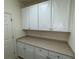 Bright laundry room with white cabinets and neutral countertops at 8191 Varenna Dr, Sarasota, FL 34231