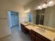 Double vanity bathroom with walk-in shower and closet at 8191 Varenna Dr, Sarasota, FL 34231