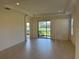 Bright living room with tile floors and sliding glass doors at 8191 Varenna Dr, Sarasota, FL 34231