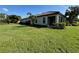 House exterior showcasing a side entrance and screened patio at 8191 Varenna Dr, Sarasota, FL 34231