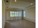 Spacious living area with tile floors and plantation shutters at 8191 Varenna Dr, Sarasota, FL 34231
