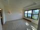 Spacious bedroom with water views and wall sconces at 8191 Varenna Dr, Sarasota, FL 34231