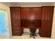 Home office with built-in desk and cabinetry at 8191 Varenna Dr, Sarasota, FL 34231