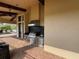 Outdoor kitchen with stainless steel appliances and stone countertops at 8191 Varenna Dr, Sarasota, FL 34231