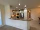 Open kitchen with granite countertops and breakfast bar at 8191 Varenna Dr, Sarasota, FL 34231
