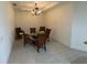 Elegant dining room with chandelier and seating for six at 8191 Varenna Dr, Sarasota, FL 34231