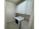 Laundry room with washer, dryer, and cabinets at 8191 Varenna Dr, Sarasota, FL 34231