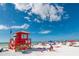 Lifeguard stand and beachgoers at Siesta Beach at 1055 Beach Rd # B-302, Sarasota, FL 34242
