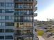 Exterior elevation of the building featuring multiple balconies and views of the community and nearby beaches at 1055 Beach Rd # B-302, Sarasota, FL 34242