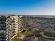 Beautiful condo building with ocean views, surrounded by palm trees and lush landscaping at 1055 Beach Rd # B-302, Sarasota, FL 34242