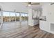 Bright, open living room area with balcony access and a modern ceiling fan at 1055 Beach Rd # B-302, Sarasota, FL 34242