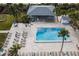 Aerial view of a community pool, complete with lounge chairs and shaded cabana at 1055 Beach Rd # B-302, Sarasota, FL 34242