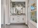 Double vanity bathroom with marble-look shower and large window at 1503 Evangelina Ln, North Port, FL 34286