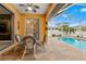 Covered patio with table and chairs, overlooking the pool at 1503 Evangelina Ln, North Port, FL 34286