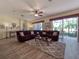 Spacious living room with sectional sofa, hardwood floors, and access to a screened patio at 4139 63Rd E Ter, Sarasota, FL 34243