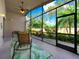Relaxing screened porch with seating area and view of lush landscaping at 4139 63Rd E Ter, Sarasota, FL 34243