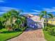 Beautiful home exterior with a landscaped yard and palm trees at 4139 63Rd E Ter, Sarasota, FL 34243