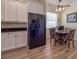 Eat-in kitchen with white cabinets, black appliances, and a breakfast nook at 4139 63Rd E Ter, Sarasota, FL 34243