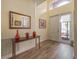 Bright and airy entryway with wood-look floors, a console table, and large mirror at 4139 63Rd E Ter, Sarasota, FL 34243