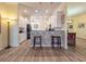 Bright kitchen with white cabinets, black appliances, and granite countertops at 4139 63Rd E Ter, Sarasota, FL 34243