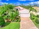 Single-Gathering home with a two-car garage and palm trees at 4139 63Rd E Ter, Sarasota, FL 34243