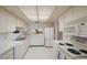Well-equipped kitchen with white cabinets and built-in microwave at 6435 Egret Ln # 409, Bradenton, FL 34210