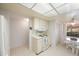 Efficient kitchen with white cabinetry, tile floors, and a breakfast nook at 6435 Egret Ln # 409, Bradenton, FL 34210