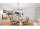 Dining area with glass table and chairs, overlooking living room at 6435 Egret Ln # 409, Bradenton, FL 34210