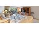 Bright living room with comfy sofas, a glass coffee table, and a built-in wooden entertainment center at 6435 Egret Ln # 409, Bradenton, FL 34210
