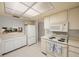 Bright kitchen with white cabinetry and a view to the living room at 6435 Egret Ln # 409, Bradenton, FL 34210