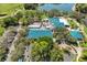 Aerial view of the community and clubhouse, with lake and golf course views at 8223 Regents Ct, University Park, FL 34201