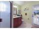 Bathroom with a walk-in shower and vanity with cherry wood cabinets at 8223 Regents Ct, University Park, FL 34201