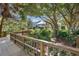 Exterior shot of the clubhouse showing the surrounding greenery and wooden walkway at 8223 Regents Ct, University Park, FL 34201