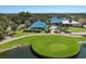 Stunning community clubhouse boasts a blue tile roof, golf course, and meticulously maintained landscaping at 8223 Regents Ct, University Park, FL 34201