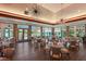 View of the dining room with tables, chairs, and large windows at 8223 Regents Ct, University Park, FL 34201