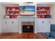 Inviting fireplace with built-in shelving and a warm ambiance at 8223 Regents Ct, University Park, FL 34201