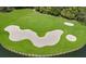 Aerial view of the golf course with sand traps and water hazard at 8223 Regents Ct, University Park, FL 34201