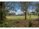 Picturesque view of the golf course surrounded by trees and lush foliage at 8223 Regents Ct, University Park, FL 34201