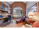 Bright home office with wood desk, chair, and large window with shutters at 8223 Regents Ct, University Park, FL 34201