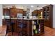 Well-equipped kitchen with wooden cabinetry, granite countertops, and an island with seating at 8223 Regents Ct, University Park, FL 34201
