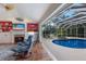 Open living area with views of the pool and outdoor living space at 8223 Regents Ct, University Park, FL 34201