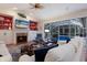 Spacious living area with fireplace, pool view, and ample seating at 8223 Regents Ct, University Park, FL 34201