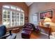 Charming office space with a large window, comfortable seating, and custom window treatments at 8223 Regents Ct, University Park, FL 34201