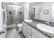 Bathroom with granite countertop, dual sinks, and a large shower at 8685 Daydream St, Sarasota, FL 34238