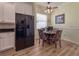 Eat-in kitchen with white cabinets, black appliances, and a breakfast nook at 4139 63Rd E Ter, Sarasota, FL 34243