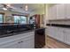 Kitchen with white cabinets, black appliances, and a granite countertop island at 4139 63Rd E Ter, Sarasota, FL 34243