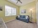 Cozy bedroom with a sofa, large window, and neutral decor at 4139 63Rd E Ter, Sarasota, FL 34243