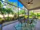 Spacious screened porch with seating area overlooking a tropical backyard at 4139 63Rd E Ter, Sarasota, FL 34243